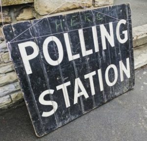 'polling station' written in white on a blackboard